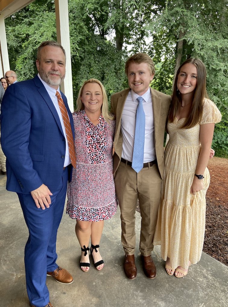 Suzanne and Mike with their son and daughter at a family wedding